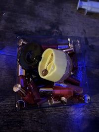 a blue light is shining on a tray of cosmetics